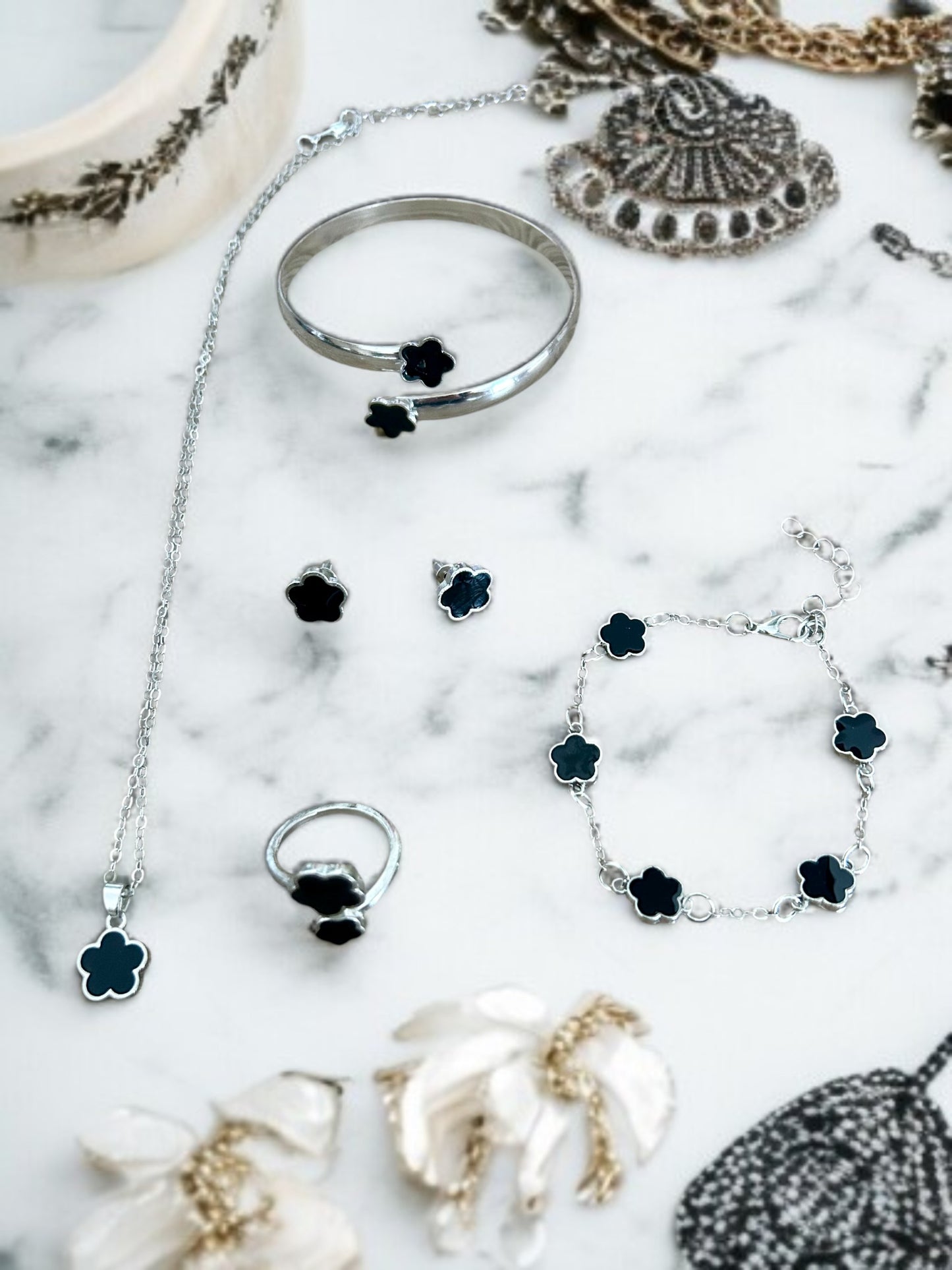 Parure comprenant 4 bijoux argentés noir/blanc ou vert fleurs